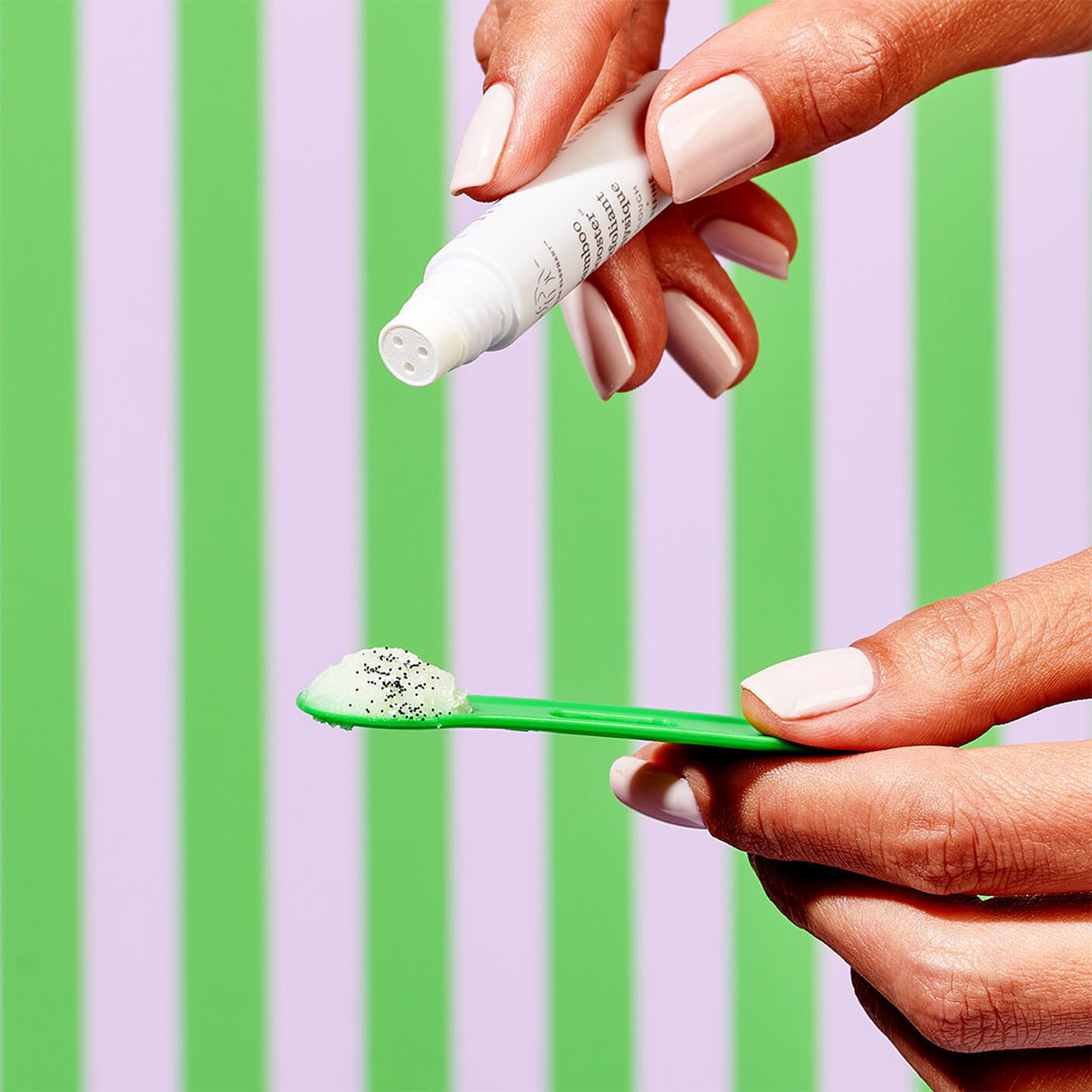 The Slaai Make Up Melting Butter Cleanser spooned on the spatula with the Bamboo booster exfoliant poured on top. 