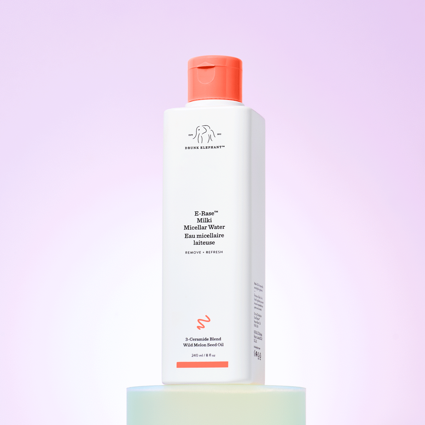 GIF of E-Rase Milki Micellar Water being poured onto the bottle on a white prop. 