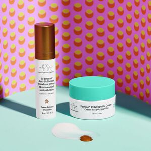 Crème D-Bronzi et Protini debout avec la texture du produit à l'avant