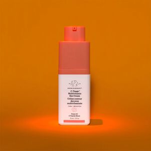 photo of a bottle of C-Tango in a spotlight against a dark orange background