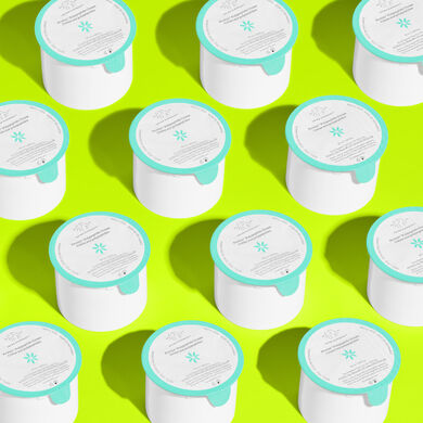 Array of Protini refill pods on green background