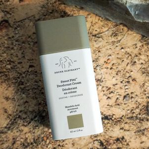 photo of a Sweet Pitti deodorant cream bottle on a rocky surface