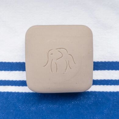 photo of a Juju bar on top of a blue and white striped towel
