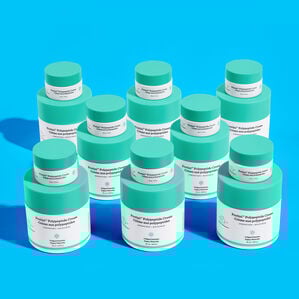 photo of Protini and Protini Minis stacked on each other scattered across a blue background