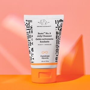 photo of a Beste midi bottle standing on top and against an orange and peach background