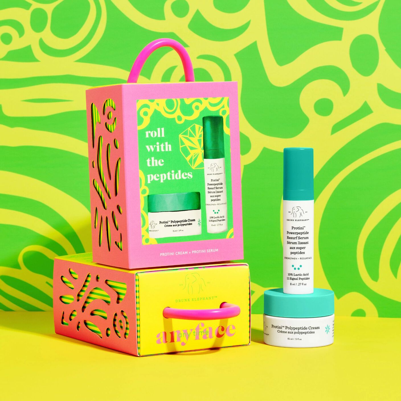 Anytime, Anyface against case with items out against a green and yellow background