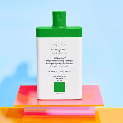 Silkamino™ Mega-Moisturizing Shampoo against stylized blue background