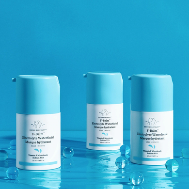 photo of three F-Balm bottles on a blues surface and a blue background