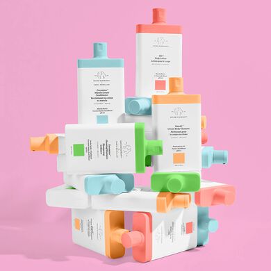 photo of an artfully stacked configuration of shampoo, conditioner, body cleanser and body lotion bottles