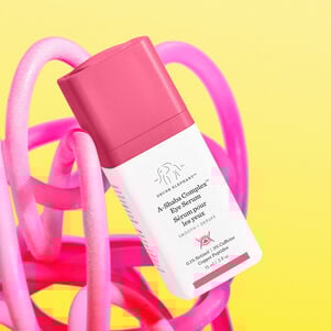 A-Shaba tilted against pink design and a yellow background