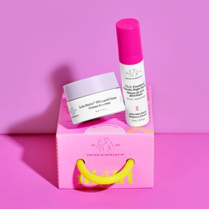 photo of a Been a Long Day canister, lid and TLC Framboos Glycolic Night Serum bottle on a dark marble surface