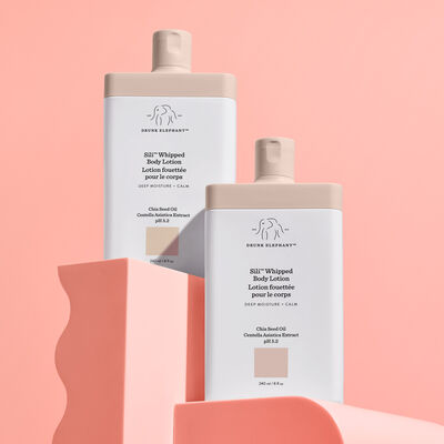 Two Sili™ Whipped Body Lotion arranged against a peach-pink background