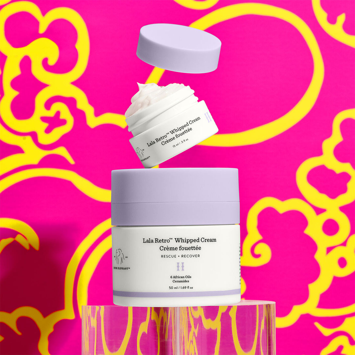 50ml Lala Retro with a 15ml Lala Retro Little on top on a pink and yellow background. 