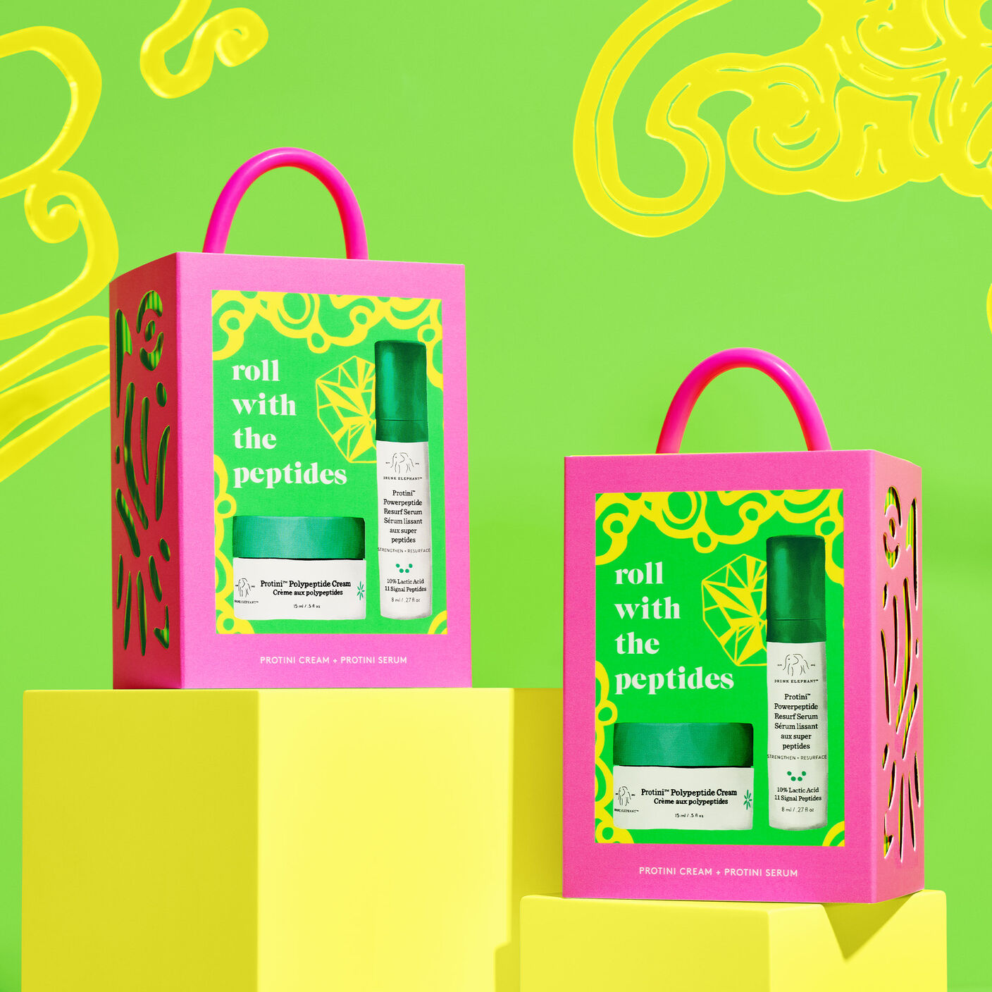 Two Anytime, Anyface cases on blocks against green background