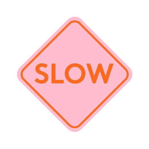 Pink diamond-shaped sign with orange "slow" text